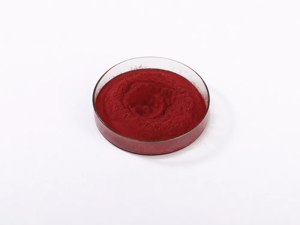 Dark red Lycopene powder in a clear dish